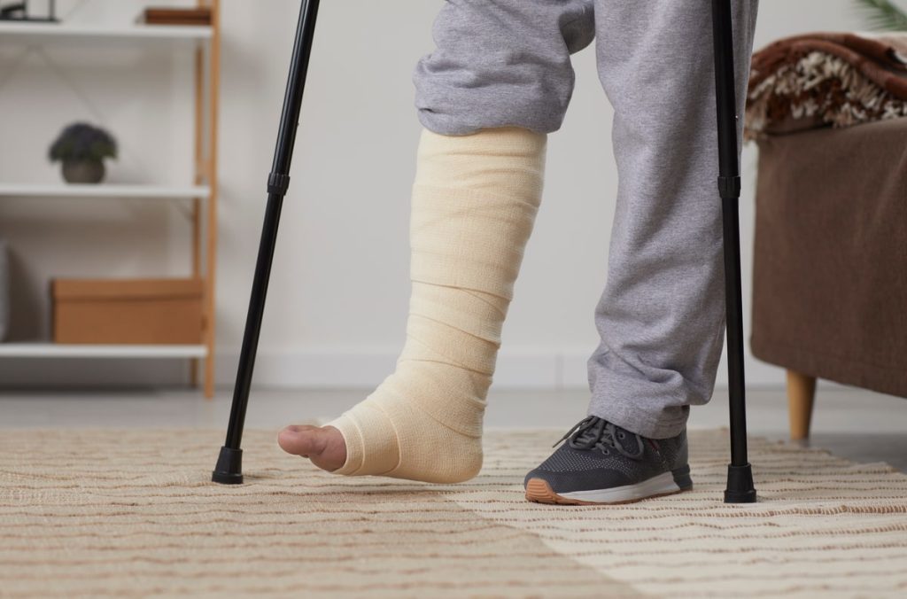 Person with bandage on leg resting as instructed by their Foot Specialist